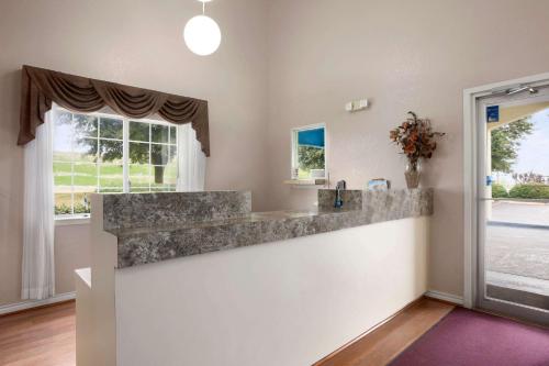 a large kitchen with a counter and a window at Travelodge by Wyndham Killeen/Fort Hood in Killeen