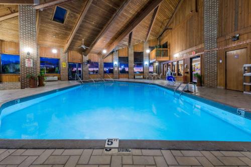 a large swimming pool in a building with a large blue pool at Baymont by Wyndham Lancaster in Lancaster