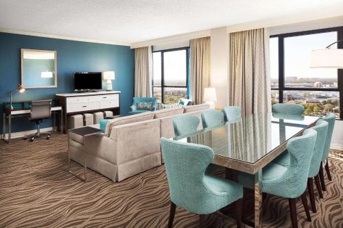 a living room with a couch and a table with chairs at Wyndham Lake Buena Vista – Disney Springs® Area in Orlando
