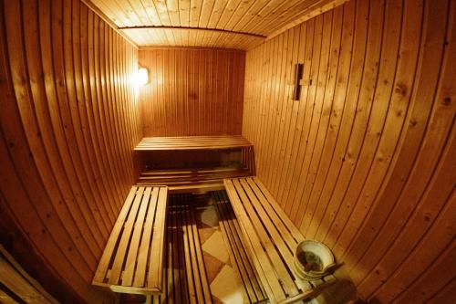 a wooden sauna with a bench in the middle at Etno hotel Balasevic Rtanj in Boljevac