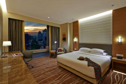 a hotel room with a bed and a large window at JEN Singapore Orchardgateway by Shangri-La in Singapore