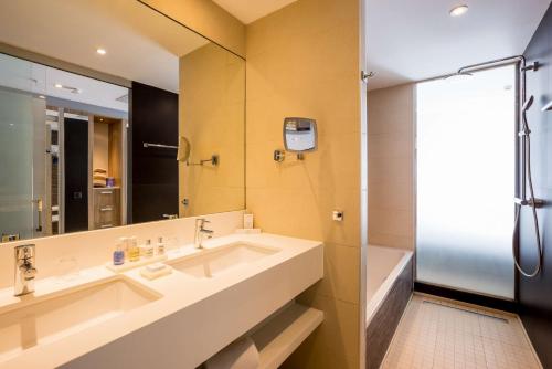 a bathroom with a large sink and a shower at Radisson Blu Resort & Spa, Gran Canaria Mogan in Puerto de Mogán