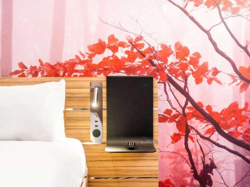 a laptop computer sitting on top of a bed at Novotel Leicester in Leicester