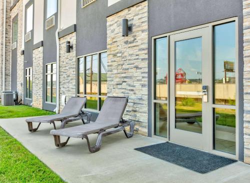 two chairs sitting on a patio in front of a building at Wingate by Wyndham Longview North in Longview