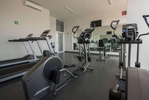 a gym with several treadmills and cardio machines at Microtel Inn & Suites by Wyndham Guadalajara Sur in Guadalajara