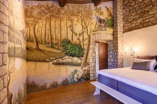 a bedroom with a wall mural of a forest at Fattorie di Celli in Poppi