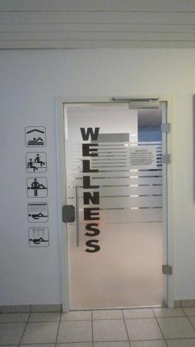 a door with signs on the side of a building at Auszeit mit Sauna und Pool in Scheidegg
