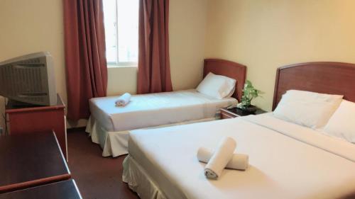 Un pat sau paturi într-o cameră la Hotel Millenium