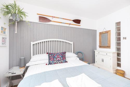 a bedroom with a bed and a desk with a pillow at Little Gem in Swanage
