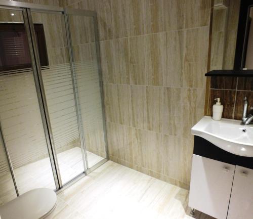 a bathroom with a shower and a toilet and a sink at Heykel Residence in Bursa