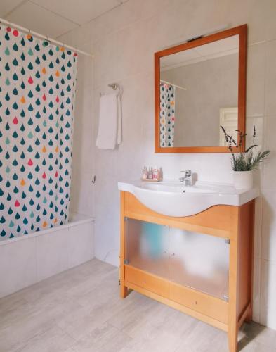 a bathroom with a sink and a mirror at Les violetes in Serra de Almós