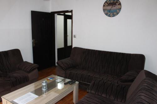 a living room with two couches and a coffee table at Apartmani Ramonda in Teslić