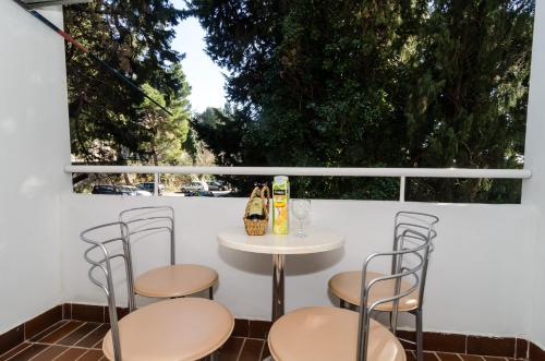 a table and chairs on a patio with a window at Apartment Iva 31 in Dubrovnik