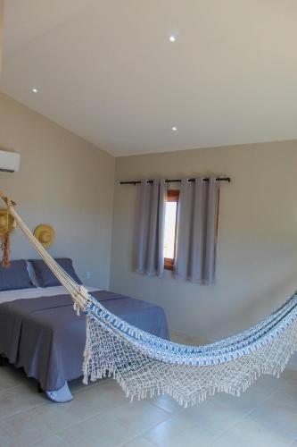 Ένα ή περισσότερα κρεβάτια σε δωμάτιο στο Pousada Casa du Soleil Camocim