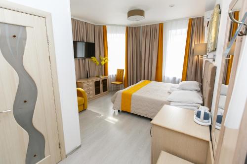 a hotel room with a bedroom with a bed and a desk at Hotel Element in Moscow