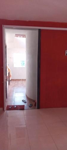 an open door to a room with a tile floor at Cantinho Nativus in Maragogi