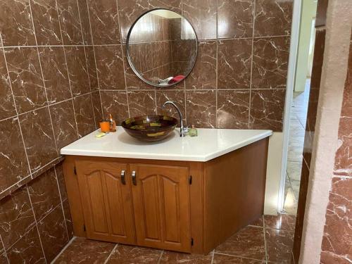 a bathroom with a sink and a mirror at Park View Apartment in Dunfermline