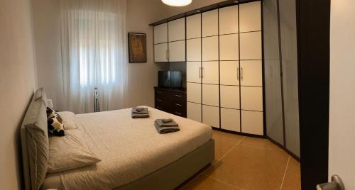 a bedroom with a bed with towels on it at CASA BARTOLINI in Bologna