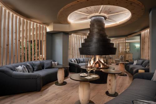 a living room with couches and a fire place at Precise Tale Seehof Davos in Davos