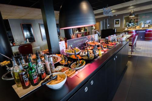 a buffet line with many plates of food and drinks at Campanile Toulouse Purpan in Toulouse