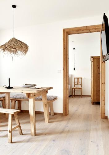 a dining room with a wooden table and chairs at Der Schmiedhof in Bayrischzell