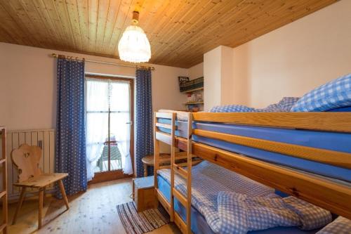 - une chambre avec 2 lits superposés et une fenêtre dans l'établissement Ferienhaus Am Steinbach, à Ruhpolding