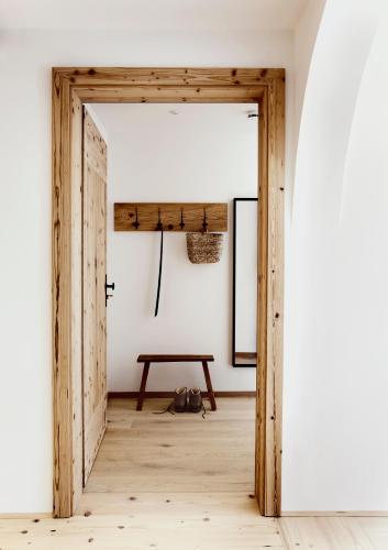 an open door in a room with a table at Der Schmiedhof in Bayrischzell