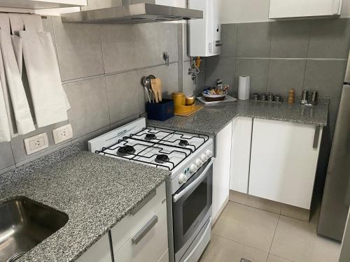 a kitchen with a stove and a sink at Patio San Ignacio in San Juan