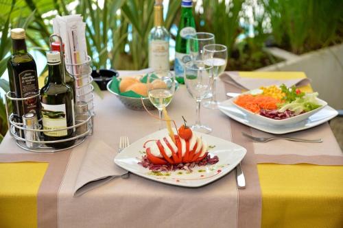 a table with plates of food and bottles of wine at Hotel Lido in Limone sul Garda