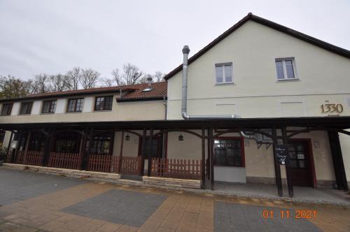 a large white building with a fence in front of it at Parkhotel Schwedt in Schwedt
