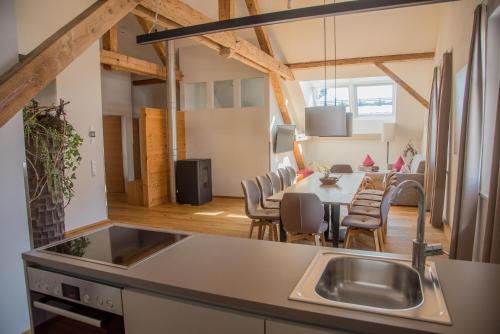a kitchen and living room with a table and chairs at adler alpen apartments in Schruns