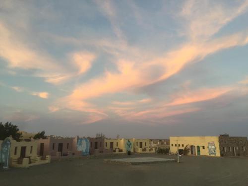 a cloudy sky above a group of buildings at Deep south Eco-lodge in Marsa Alam City