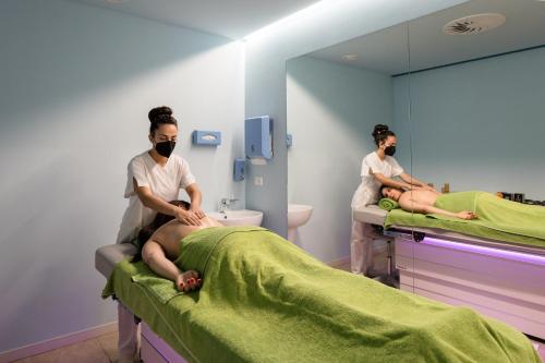two women in a hospital room wearing face masks at Hotel Du Parc in Sirmione
