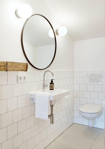 a bathroom with a sink and a mirror at Der Schmiedhof in Bayrischzell
