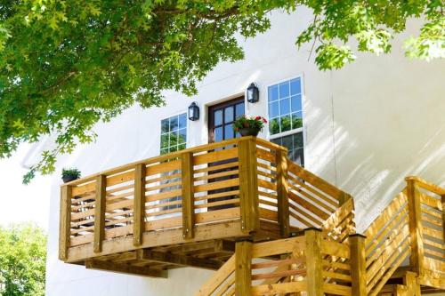a deck in front of a house with a window at Spacious Carriage House with Park Views Near Frankfort Ave & Downtown in Louisville
