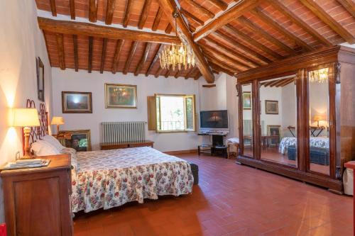 a bedroom with a bed and a television in it at Ginestraio in Santalbino by VacaVilla in Sorrezzana