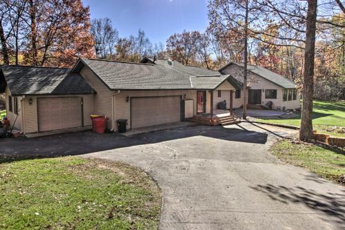 a house with a garage and a driveway at Cabin with Fire Pit and Movie Room, 1 Mi to Lake in Pequot Lakes