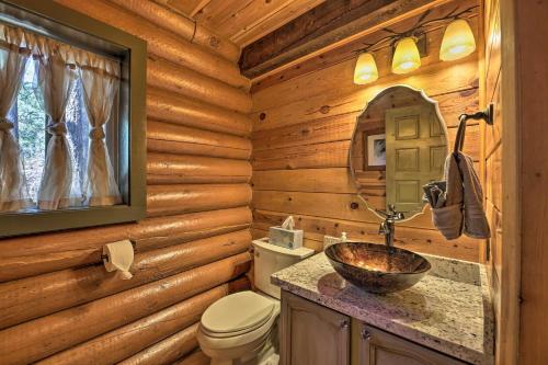 a log cabin bathroom with a sink and a toilet at Near Dining, Hiking and Golf Pinetop Log Cabin! in Indian Pine