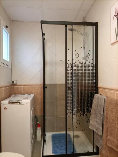 a shower stall in a bathroom with a toilet at CALIMA Lodge Corralejo in Corralejo