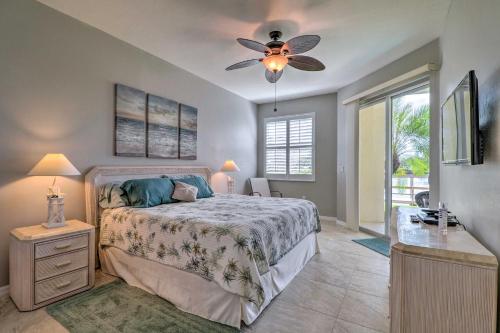 a bedroom with a bed and a ceiling fan at Waterfront Punta Gorda Condo with Pool Access! in Burnt Store Marina