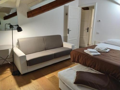 ein Wohnzimmer mit einem Bett und einem Sofa in der Unterkunft Villa Peachey (Picci), Grazioso Appartamento in Stresa