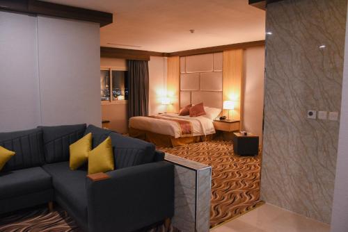a living room with a couch and a bed at Florida Inn Hotel in Najran