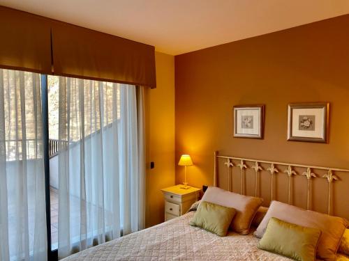 a bedroom with a bed and a large window at PROBER_SISCARO in Encamp