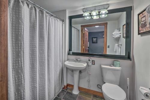 a bathroom with a sink and a toilet and a mirror at Ski-InandOut Snowshoe Retreat with Resort Amenities! in Snowshoe