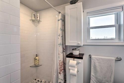 a white bathroom with a shower and a window at Seaside SK Getaway Steps to Matunuck Beach! in South Kingstown