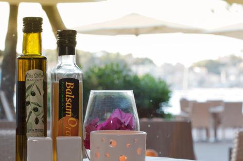 two bottles of wine and a cup on a table at Los Geranios in Port de Soller