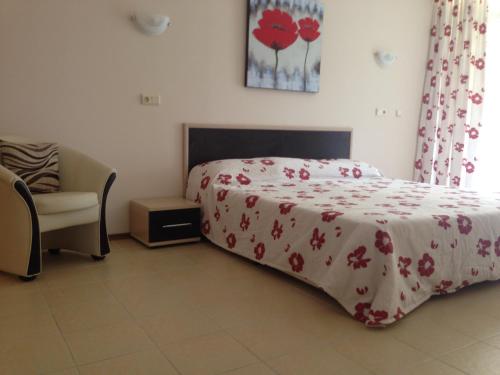 a bedroom with a bed with a red and white blanket at PSB Apartments in Midia Resort Aheloy in Aheloy