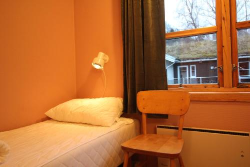 a small bedroom with a bed and a window at Åndalsnes Hostel in Åndalsnes