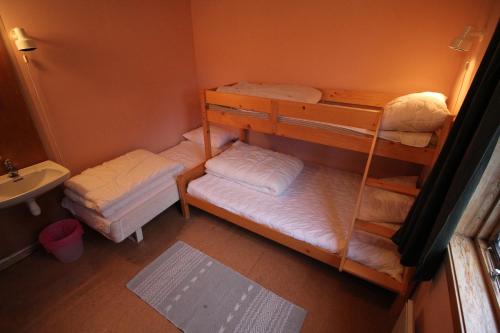 a room with two bunk beds and a sink at Åndalsnes Hostel in Åndalsnes