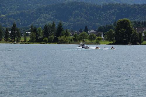 a group of people in a boat on a lake at Hotel Seehang Garni in St. Wolfgang